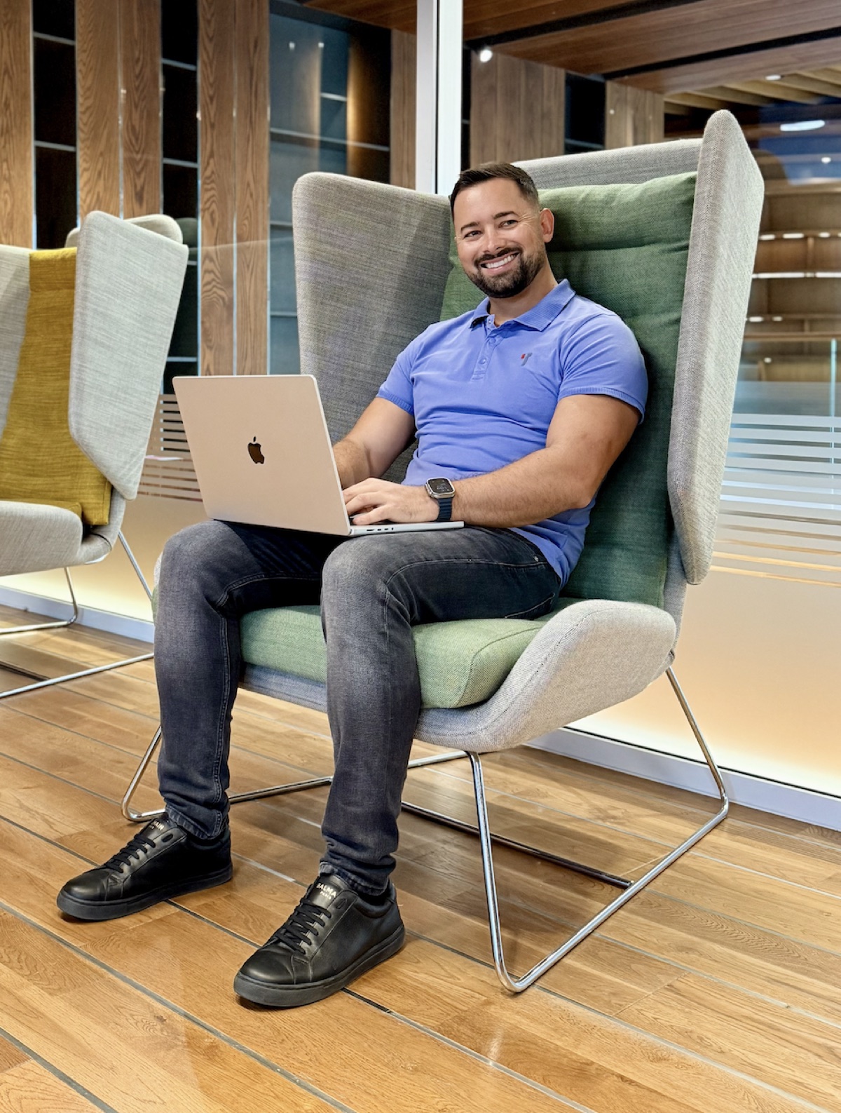 Ivan Votipka working on his laptop in a lounge chair